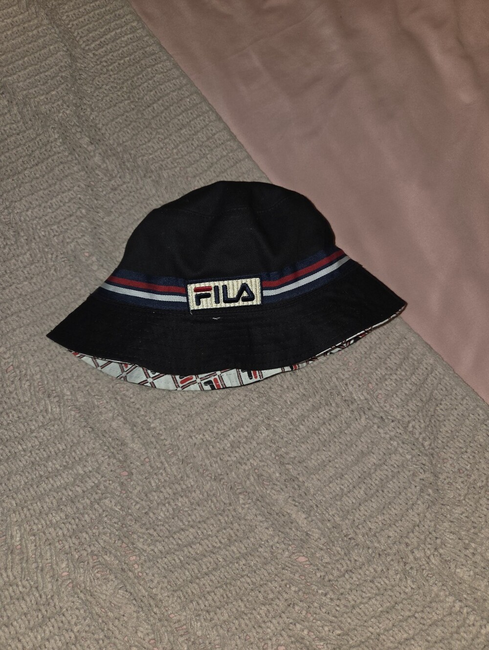 FILA embroidered logo patch over a navy, white, and red striped band. The revers